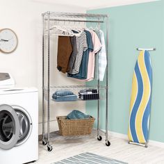 a washer and dryer in a laundry room with blue walls, white flooring and metal shelving