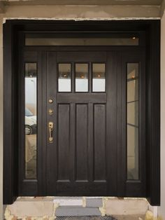 a black front door with two sidelights