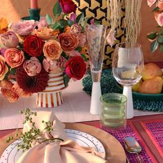 the table is set with flowers and plates