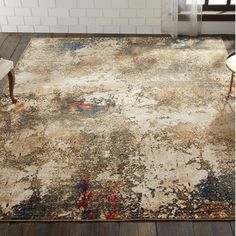 an area rug with faded paint on it in a living room next to a window