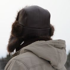 Real beaver fur trapper hat made with recycled beaver fur and brown leather for men. Wonderful fur hat for winter made from genuine leather and durable materials. You can tie the earflaps down or back using the cords. Warmer than the competition, this hat is lined with a very soft, non-irritating black woolen fabric, which will keep you warmer than a usual quilted lining. A velcro strip inside allows the hat to be tightened as needed. The recycled fur comes from good second-hand fur coats, which Beaver Hat, Hat For Winter, Fur Trapper, Fur Trapper Hat, Trapper Hat, Trapper Hats, Fur Hat, Fur Coats, Hat For Man