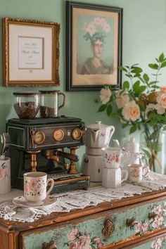 an old fashioned coffee maker on top of a dresser in a green room with pink flowers