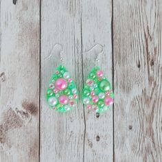 "These teardrop earrings are made with resin and glitter. They are then covered with faux pearls and glass rhinestones. The green glitter base sparkles between the rhinestones and pearls. The pearls and rhinestones are hand placed individually. Their placement differs on each earring, making each one unique. Earring size (not including fish hook): 1.5 inches long The fish hook ear wires are made with a nickel free stainless steel. 925 sterling silver and gold tone ear wires are available as an u Green Teardrop Beaded Earrings For Party, Green Dangle Teardrop Earrings For Party, Green Teardrop Earrings For Party, Green Teardrop Beaded Earrings For Gifts, Pearl Teardrop Earrings, Unique Earring, Floor Decal, Earring Making, Glitter Earrings