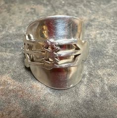 This ring is made from a whole solid silver teaspoon, by William Henry Leather, Birminham early 1900's. It is solid silver.  I attach a photo of the original spoon. size U Comes with box and free postage to UK Please note in it's original life as a spoon it will have been used by many people over the years, there will therefore be  evidence of use and slight imperfections, but this adds to it's uniqueness and authenticity. Antique Silver Open Signet Ring, Silver Antique Signet Ring, Antique Hand Cast Silver Rings, Vintage Silver Wide Band Ring, Vintage Silver Engraved Wide Band Ring, Silver Spoon Ring, William Henry, Spoon Ring, Spoon Rings