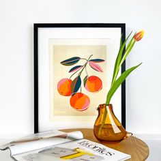 there is a vase with some flowers in it on the table next to books and magazines