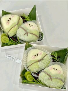 two small stuffed animals are sitting in some green leafy plants and wrapped in white paper