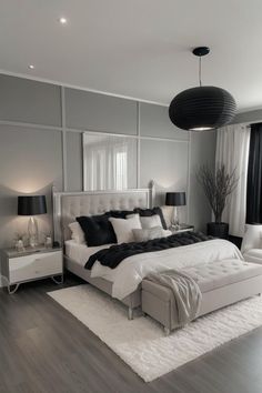 a large white bed sitting in the middle of a bedroom next to two lamps on either side of it