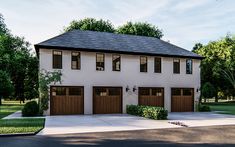 a two story house with three garages on each side