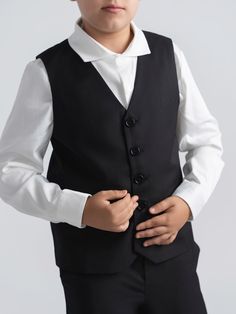 Our tailored black tux vest adds the finishing touches to a 3 piece suit. Buttons can be left button or unbuttoned. Pair with matching black double breasted blazer and black tailored dress pants for a sharp effortless look. Explore Mofi Clothing: meticulously crafted for husky, broader, and stout boys, or any boy who simply needs a bit more room. Our designs prioritize comfort without compromising on style, ensuring every child feels confident and comfortable. Model 1 wearing size 12. Model 2 we Sleeveless Black Blazer For Business, Sleeveless Black Business Blazer, Classic Black Three-piece Suit For Black-tie Events, Classic Black Double Breasted Suit For Black-tie Events, Sleeveless Black Blazer For Formal Occasions, Formal Sleeveless Black Blazer, Black Sleeveless Formal Blazer, Sleeveless Black Formal Blazer, Black Single-button Suit For Black Tie Events