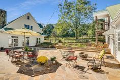 an outdoor patio with chairs, tables and umbrellas