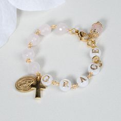 This stunning Baptism bracelet is a truly divine piece that combines elegance and spiritual significance. Crafted with natural rose quartz, it features gold plated Miraculous medal and cross charms that symbolize protection and faith. The bracelet is personalized with a handcrafted initial letter, adding a unique touch to this meaningful piece. Perfect for commemorating a special occasion or as a thoughtful gift, this bracelet is a beautiful reminder of faith and blessings. *MATCHING ROSARY PRAYER: https://www.etsy.com/au/listing/1558150192/personalized-rosary-beads-pink-rosary *Materials:  High Quality 18k gold plated Stainless Steel charms * Gemstone: Genuine rose quartz beads, round shape, 6mm, faceted * Closure: adjustable finial, lobster clasp * Letter beads: handmade, mother of pearl Personalized Rosary, Rosary Prayer, Rosary Bracelet, Rose Quartz Beads, Rosary Beads, Letter Beads, Catholic Gifts, Initial Letters, Cross Charms