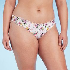 This Ruffle Cheeky Bikini Bottom from Shade & Shore™ is adorned with a ditsy floral print for extra charm. It features a low-rise, hipster silhouette with soft ruching and ruffles on the edging for a sweet finish. The stretchy fabric with elastic at the leg openings provides comfortable movement, and the opaque construction offers coverage for confident wear. Pair them with a coordinating bikini top to complete your swim style. Shade & Shore™: Found exclusively at Target. Feminine Stretch Swimwear With Floral Print, Feminine Floral Print Stretch Swimwear, Feminine Stretch Floral Print Swimwear, Summer Swimwear With Lace Trim Briefs, Summer Swimwear With Lace Trim And Brief Shape, Swim Style, Shades For Women, Ditsy Floral Print, Charm It