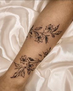 a woman's arm with flowers on it