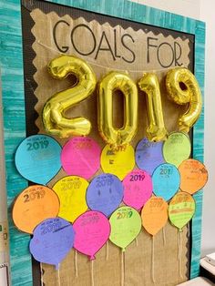 a bulletin board with balloons and the words goals for 2013 written in gold on it