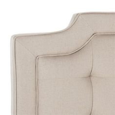 an upholstered headboard with buttons on the back and arms, in beige linen