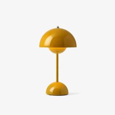 a yellow lamp sitting on top of a table