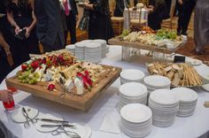 a table topped with plates and trays filled with different types of food next to each other