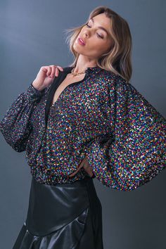 The Freedom Calls Sequin Top combines timeless design with modern style. It features a shirt collar, long sleeves, and an elasticized waistband for a figure-flattering fit. The glimmering sequins add a touch of glamour to any occasion. Details Self : 100% Polyester Lining : 100% Polyester Size & Fit - Model is 5`8" And Wearing Size Small - Measurements Taken From Size Small - Approx. Length: 21" Long Sleeve Tops With Contrast Sequin For Night Out, Chic Long Sleeve Glitter Tops, Contrast Sequin Long Sleeve Tops For Night Out, Sequin Long Sleeve Blouse For Date Night, Long Sleeve Sequin Blouse For Date Night, Stretch Sequined Blouse For Night Out, Sequin Stretch Blouse For Night Out, Stretch Sequin Blouse For Party Season, Glamorous Glitter Blouse For Night Out