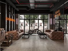 a motorcycle is parked in the middle of a room with leather couches and chairs