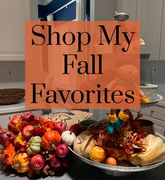 two plates with pumpkins, gourds and other fall decorations on them in the kitchen