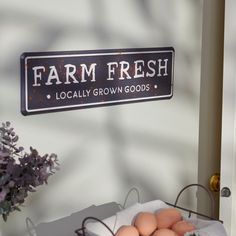 eggs sit in a basket next to a sign that reads farm fresh locally grown goods