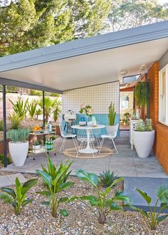 an outdoor patio with steps leading up to the back door and table on the porch