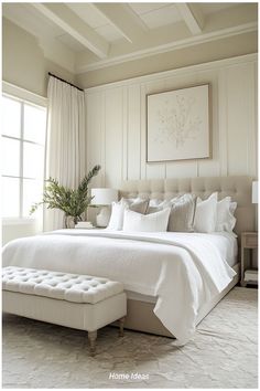 a white bed sitting in a bedroom next to a window