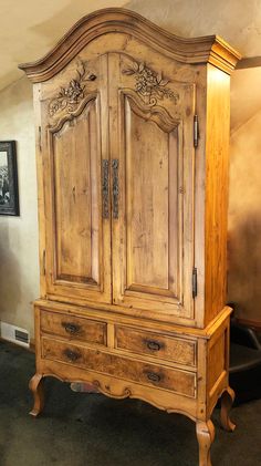 an old wooden armoire sitting in a room