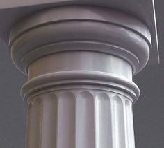 a close up of a white pillar with a clock on it's top and bottom