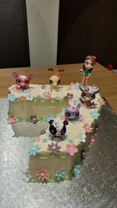 a birthday cake with three little cartoon characters on it