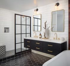 a bathroom with two sinks, mirrors and a bathtub