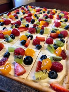 the fruit pizza is ready to be cut into squares and put in the oven for consumption