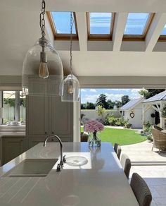 a large kitchen with an island and skylights