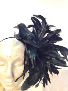 "Bird fascinator- Kentucky Derby- Feather Headband- Ravens- Crow- Lagen look headpiece - Goth- Steampunk- Mad Hatter Hello, This Bird was the first one I ever made and it started a whole collection for me. It is perfect to add whimsy and is just so fun you'll be the life of the party. A great conversation piece I call him Henry. This black feather fascinator has a black feather bird with a puff of black coque feathers. It has great movement. It not a real bird, its styrofoam covered with feather Black Bird Costume, Raven Costume, Crow Costume, Steampunk Halloween, Bird Costume, Black Fascinator, Feather Fascinators, Feather Headband, Black Feathers