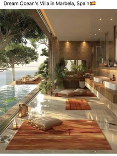 a bathroom with a large window overlooking the water and trees in front of it is featured in an article titled dream ocean's villa marbella, spain