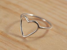 Handmade open heart ring. The heart was hand formed from single sterling silver wire (1.3mm thickness) then solder onto the skinny band. These ring has a smooth and traditional shine finish. Measuring : ~ 12x8 mm Sterling silver heart ~ Made to order to fit your ring size. Between sizes are also available. Please leave the note to seller at check out. Do not know your ring size? Please follow these instructions >> http://designbygam.blogspot.com/ Note to my lovely international customers : Sterling Silver Open Heart Ring, Open Heart Ring, Handmade Silver Ring, Engagement Wedding Ring Sets, Silver Rings Handmade, Open Heart, Engagement Jewelry, Love Ring, Sterling Silver Heart