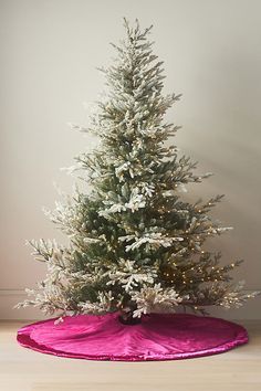 a small white christmas tree on a pink blanket