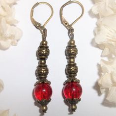 This Gorgeous Beaded Bohemian Style Earring Set Is Brand New And Hand Crafted By Me - Wvluckygirl. Done With Crackled Red Glass Beads That Sparkle A Little In The Light. They Have Rustic Antiqued Brown Bronze Toned Costume Jewelry Beads. The Pair Dangle & Drop From Lever Backs For Women's Pierced Ears. Measure 2 Inches Tall & Just Over 1/4 Inch Wide. Each Single Earring Weighs 2.9 Grams. Very Unique And Eye-Catching. You Will Love The Length Of Them. Buy Them Now Before Someone Else Does! Fashio Vintage Red Beaded Earrings For Gift, Vintage Red Beaded Earrings As Gift, Handmade Vintage Red Beaded Earrings, Vintage Red Jewelry With Dangling Beads, Elegant Red Metal Beaded Earrings, Elegant Red Beaded Metal Earrings, Red Metal Dangle Beaded Earrings, Red Metal Beaded Drop Earrings, Red Metal Drop Beaded Earrings