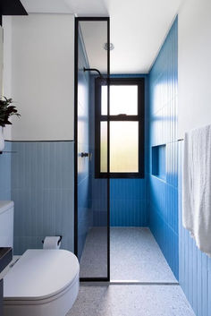 a bathroom with blue and white tile walls