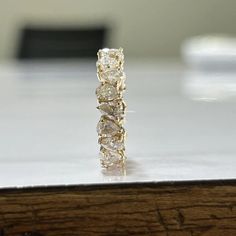 a three stone diamond ring sitting on top of a table