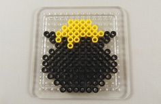 a plastic container filled with black and yellow beads