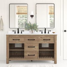 a bathroom vanity with two mirrors above it