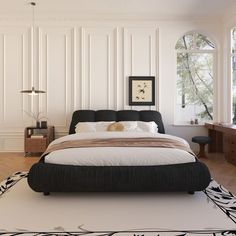 a large bed sitting in the middle of a bedroom