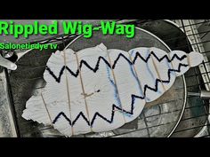 a fish made out of paper sitting on top of a wire rack with words ripped wig - wag