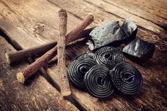 several pieces of metal sitting on top of a wooden table next to sticks and rocks