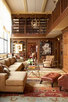 a living room filled with lots of furniture and bookshelves