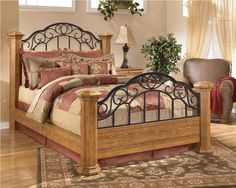 a bed with a wooden frame and metal headboard