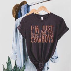 I'm Just Here For The Cowboys Shirt, Cowgirl Shirt UNISEX T-Shirt Bella+Canvas 3001 .: Black, Brown, Soft Cream, Red: 100% cotton    Dark Grey Heather: 52% cotton, 48% polyester .: Light fabric (4.2 oz/yd²) .: Runs true to size ❤️ Returns & exchanges I don't accept returns, exchanges, or cancellations All sales are final. Thank you for supporting our small business! Western Cricket Shirts, Cowboy Shirts Women, Country Shirt Ideas Vinyl, Country Shirts For Women, Western Tshirt Designs, Western Tee Shirts, Rodeo Clothes, Western Shirts For Women, Cricket T Shirt