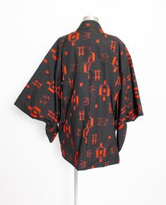 "A gorgeous vintage 1980s - late 70s haori robe. Black mid weight cotton with read abstract design weave. Features wide, long sleeves and open relaxed fit to the thigh. Partly lined with ivory nylon with a subtle floral print. Single tie closure at interior waist. Label: No maker's label remains Fits like size: S-M - shown on a modern sz 4 mannequin Bust: 40\" laid flat pit to pit Waist: 42\" laid flat Hips: Free Length: 30\" Shoulder: 24\" Sleeve: 13.5\" Condition: Excellent. Please do not hesi Vintage Red Cotton Kimono, Red Vintage Cotton Kimono, Haori Robe, Red Kimono, Kimono Japanese, Womens Robes, Abstract Design, Black Red, Kimono Top