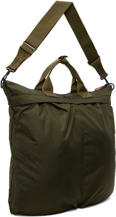 Lightweight nylon canvas tote in khaki. · Press-stud tab at webbing carry handles · Adjustable and detachable crossbody strap · Logo patch at face · Patch pockets and pleats · Zip closure · Zip pocket at interior · Fully lined · H16.5 x W18 x D2 Supplier color: Olive drab Khaki Nylon Tote Bag, Military Travel Bag With Pockets, Nylon Satchel With Detachable Strap In Tote Shape, Nylon Tote Satchel With Detachable Strap, Nylon Tote Shoulder Bag With Multiple Pockets, Nylon Shoulder Tote Bag With Multiple Pockets, Military Style Nylon Bags For Everyday Use, Military Style Bags With Multiple Pockets For Everyday Use, Military Bags With Multiple Pockets For Everyday Use